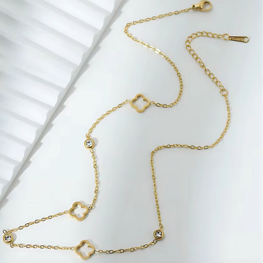 Gold necklace with zircon pendant styled with a beige fall outfit.