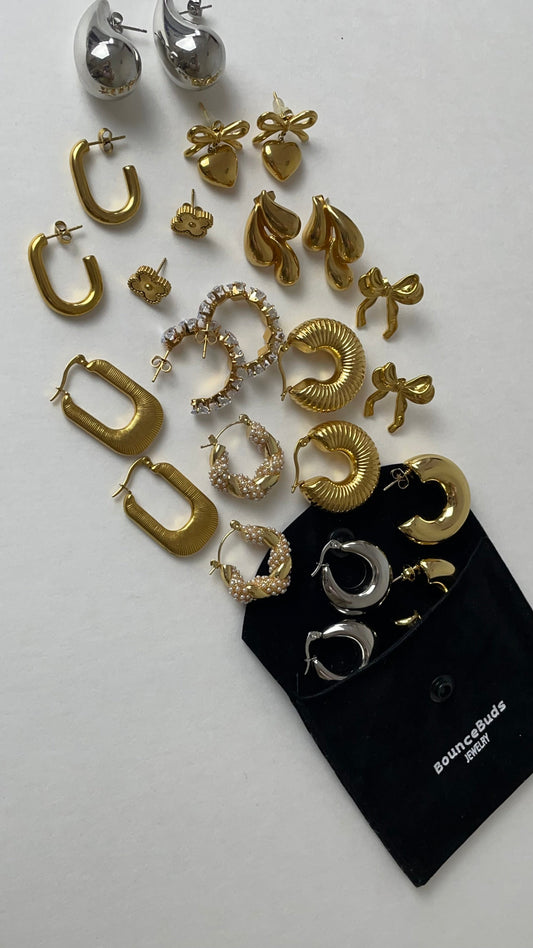 Close-up of a woman wearing layered gold and silver necklaces and rings.
