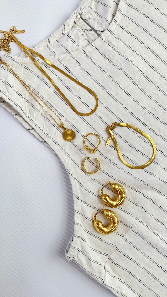 Elegant pearl necklace styled with a white linen dress for a summer look.
