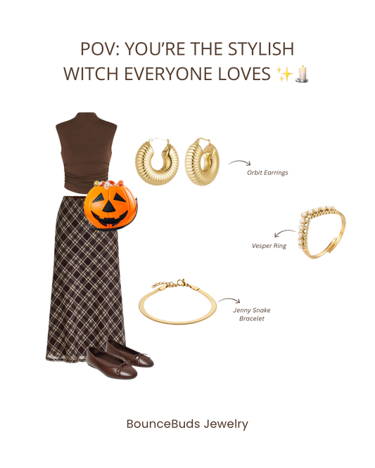 Woman wearing layered gold necklaces with a black Halloween dress and dark lipstick.